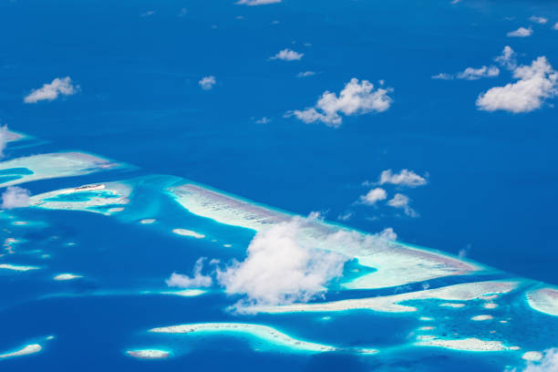 istock Window view from airplane on maldivian atoll with islands 1312272520