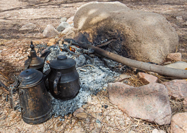 istock Campfire with cooking pots in hot desert climate 1312273488