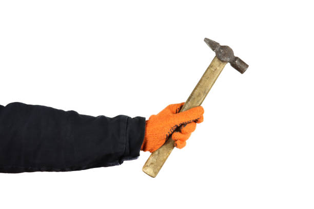 istock hand with hammer isolated on white background 1312276902