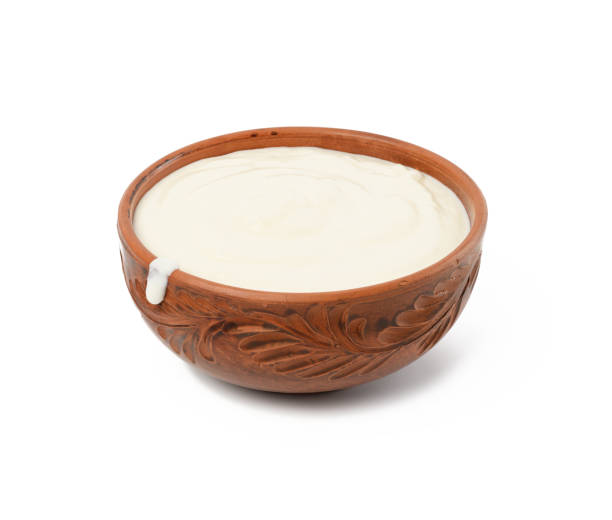 istock sour cream in a brown ceramic bowl on a white background 1312279547