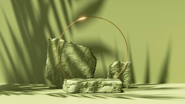 istock 3d render, abstract green background with leaves shadows and bright sunlight. Minimal scene with cobblestone podium and golden round frame, showcase for organic cosmetic product presentation 1312281163