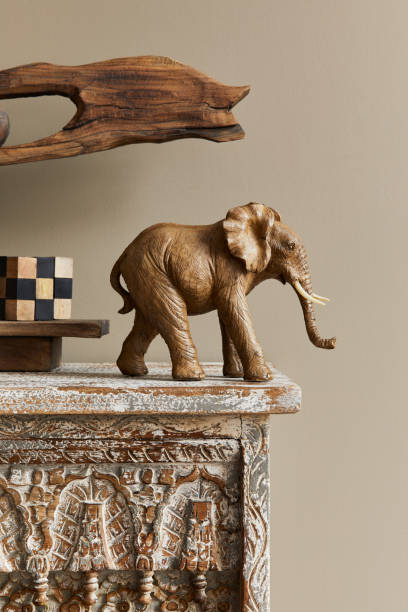 istock Stylish composition at moroccan interior with wooden shlef, cube, design elephant figure and decoration in modern home decor. Details. Template. 1312281732