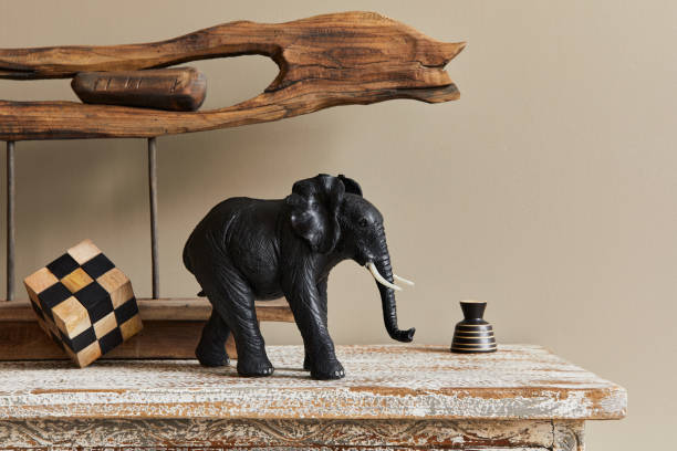 istock Stylish composition at moroccan interior with wooden shlef, cube, design elephant figure and decoration in modern home decor. Details. Template. 1312281857