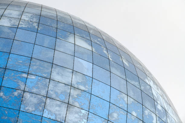istock Glass spherical modern building with reflection of blue sky 1312282952