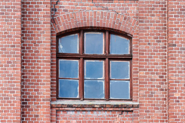 istock One arched glass window on old red brick wall 1312283000