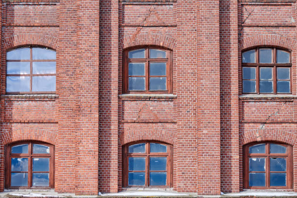 istock Six arched glass windows set in red brick wall 1312283037