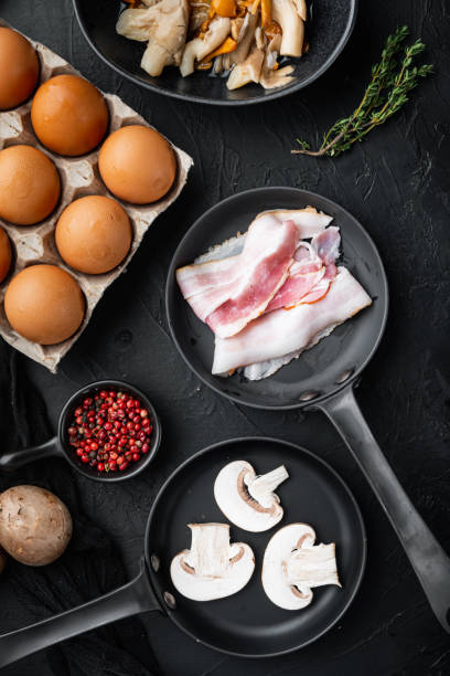 istock Healthy breakfast ingredients for fried eggs, on black background, top view flat lay 1312283482