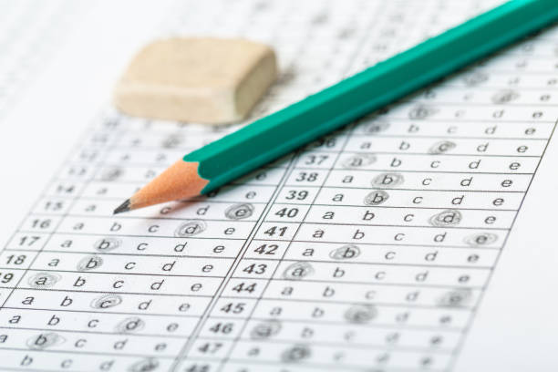 istock testing in exercise and exam paper. computer sheet with pencil in school test room, education concept. filling in answers in pencil 1312283822