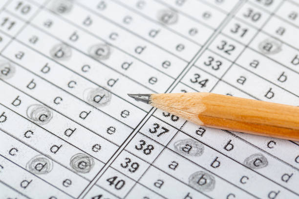 istock testing in exercise and exam paper. computer sheet with pencil in school test room, education concept 1312283831