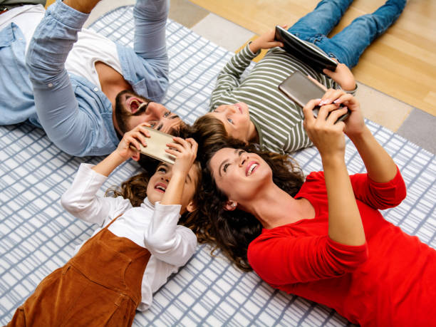 istock Family using mobile phones together 1312283917
