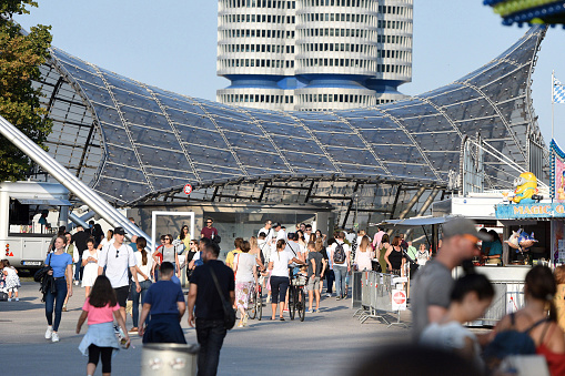 Part of the roof of the olympic station, in the background the BMW headquarters and visitors to the \