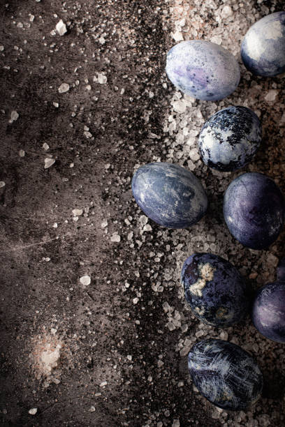 istock Outer space concept. Still life of salt and eggs on a concrete background. Marble Easter eggs laid out on salt in the form of a milky way. 1312284885