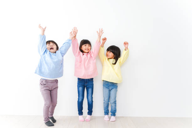 istock Three kindergarteners lined up on the wall 1312285620