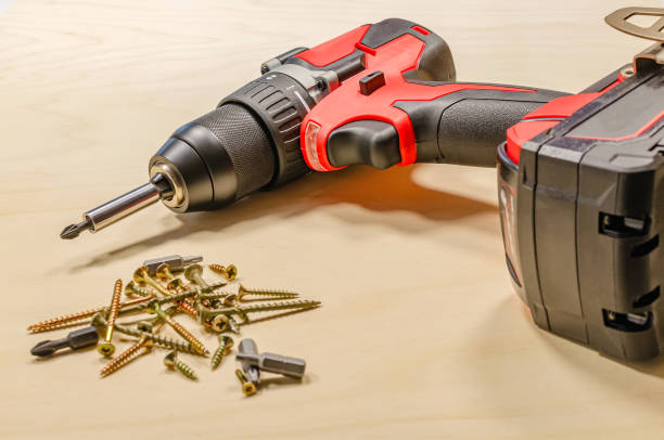 istock Red cordless drill on a black background. Screw tightening tool 1312289631