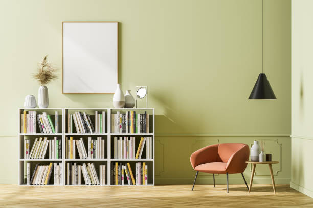 istock Bright waiting room interior with bookcase, armchair and poster 1312289814