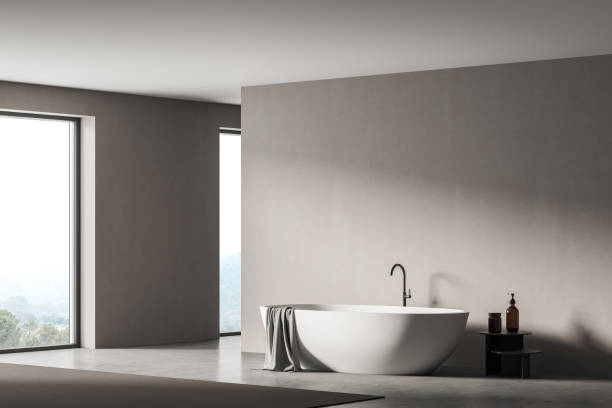 istock Modern bathroom interior with white bathtub, shampoo table, panoramic window. Room designed in eco minimalist style. Mock up wall space. No people. 3D Rendering 1312289952