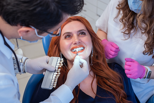 Doctor using color samples to show good results.