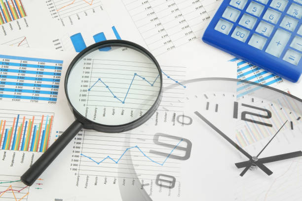 istock Charts, graphs, calculator, magnifying glass and clock 1312292557