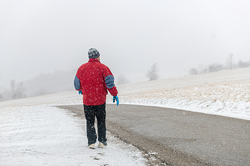 Mature man is walking and enjoying winter idyll, Primorska, Julian Alps, Slovenia, Europe