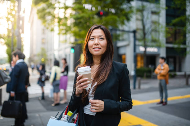istock Asian Business Woman With A Coffee Cup 1312294316