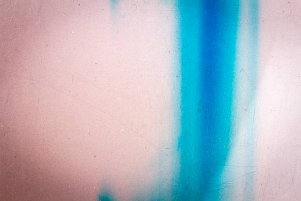 Abstract blue and purple scratched film texture background with heavy grain, dust and light leak