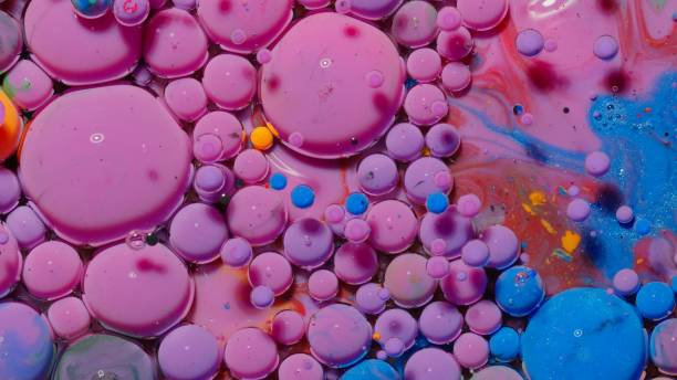 istock Bubbles float in liquid paint, mixing ink, oil and milk, abstract multicolor hypnotic painting 1312295777