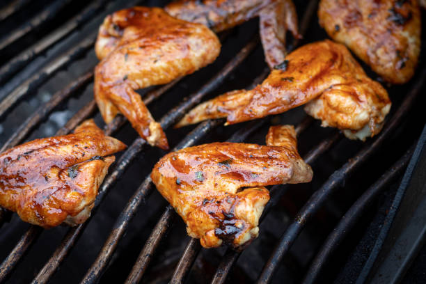 istock glazed bbq chicken wings cooked on the grill closeup 1312295912