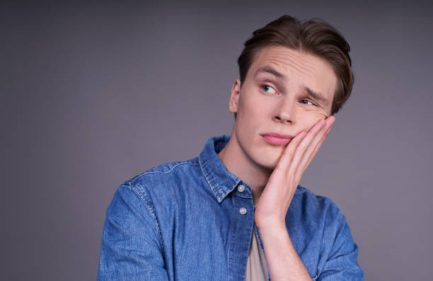 istock The young man looks away with a pensive, sad, calm expression. 1312296588