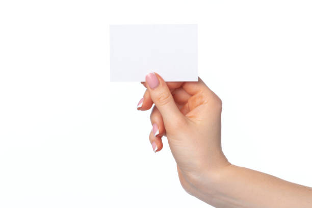 istock Female hand with blank white business card isolated on white 1312296798