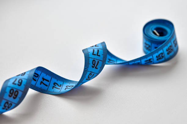 istock Blue measuring tape isolated on white background 1312296891