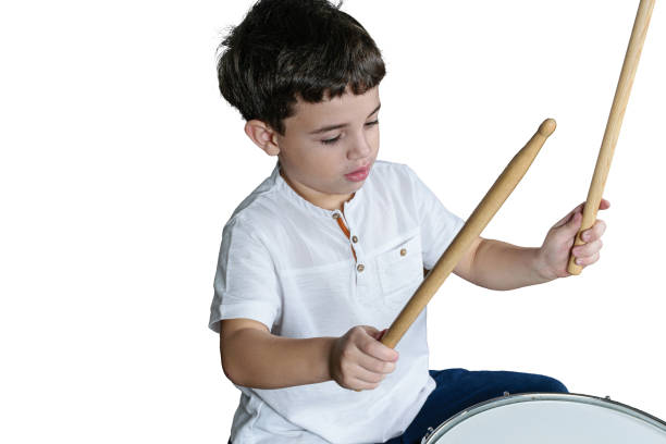 istock 7 year old child with his dumsticks ready to play the drums. White background. 1312298832