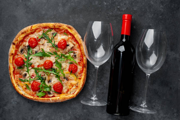 istock delicious pizza, red wine and glasses on a stone background with copy space for your text 1312299722