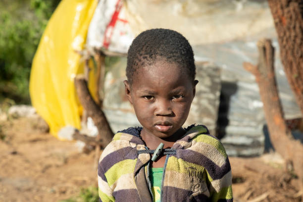 istock African child with a tough look standing next to a shack 1312299762