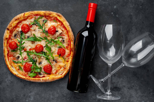 istock delicious pizza, red wine and glasses on a stone background with copy space for your text 1312299830