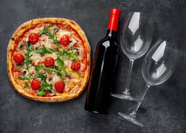 istock delicious pizza, red wine and glasses on a stone background with copy space for your text 1312299865
