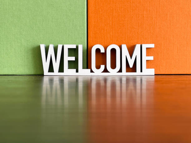istock Welcome sign on green orange background 1312299942