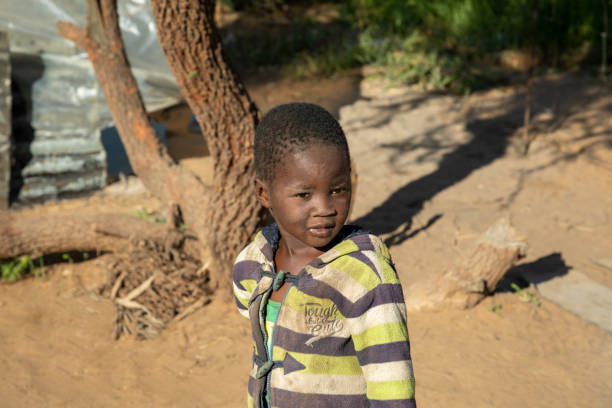 istock African child with a tough look standing in his yard 1312300876