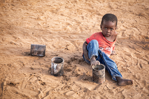 African child playing in the sand in a village in Botswana