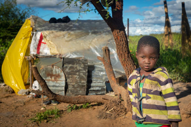 istock African child with a tough look standing in his yard 1312301060