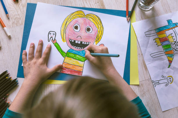 istock Little child drawing at home. Self portrait. 1312301617