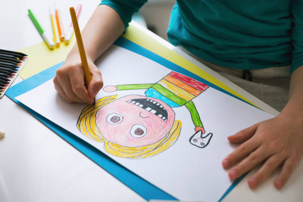 istock Little child drawing at home. Self portrait. 1312301639