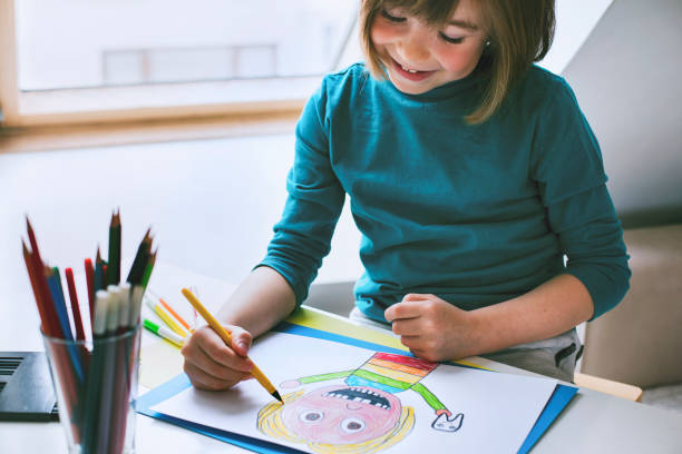 istock Happy boy drawing at home. Self portrait. 1312302244