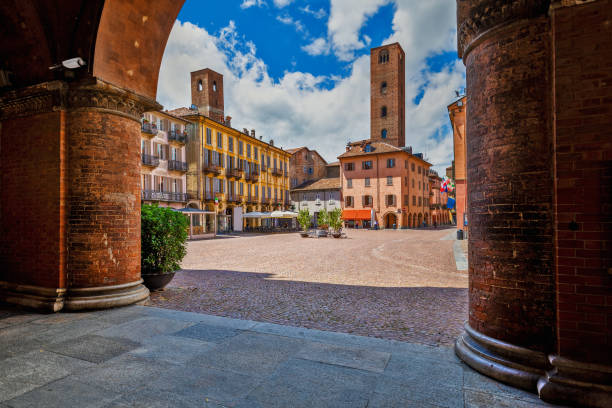 Piazza Duomo and old historic houses in Alba, Italy. View of cobblestone town square among old houses and medieval towers under beautiful sky in Alba, Piedmont, Northern Italy. alba italy photos stock pictures, royalty-free photos & images