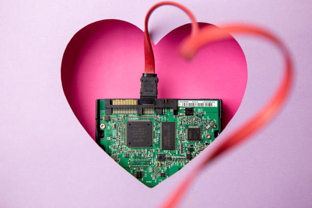 istock The green printed circuit board with microprocessors is located in a pink heart-shaped cavity. All around is purple. 1312303581
