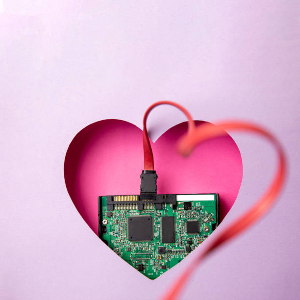 istock The green printed circuit board with microprocessors is located in a pink heart-shaped cavity. All around is purple. 1312304118