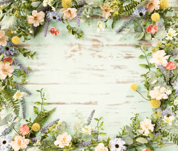 Spring flower wreath garland frame on an old rustic blue wood background Spring flower wreath garland on an old rustic blue/green wood background spring time flowers stock pictures, royalty-free photos & images