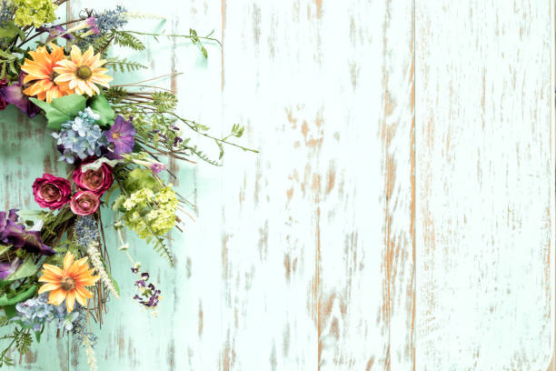 istock Spring flower wreath on an old rustic blue wood background 1312305239