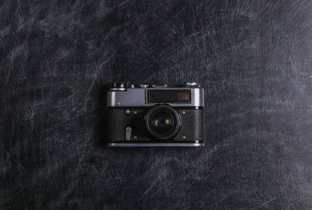 istock Retro film camera on chalk black board close-up. Top view 1312307149