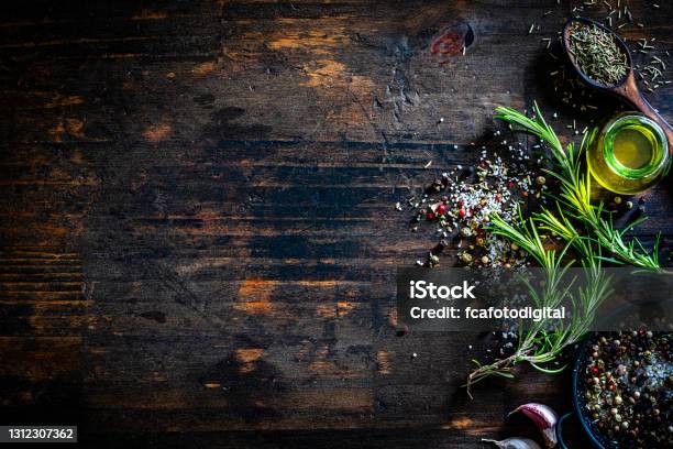 Culinary Border Of Rosemary Salt Pepper And Oil Stock Photo - Download Image Now - Wood - Material, Backgrounds, Table