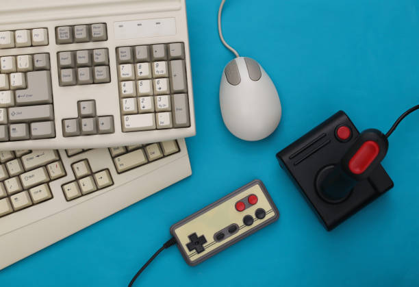 istock Old keyboard, joystick, gamepad and pc mouse on blue background. Retro gaming. 80s. Top view 1312308074